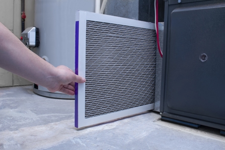 Replacing furnace air filter.